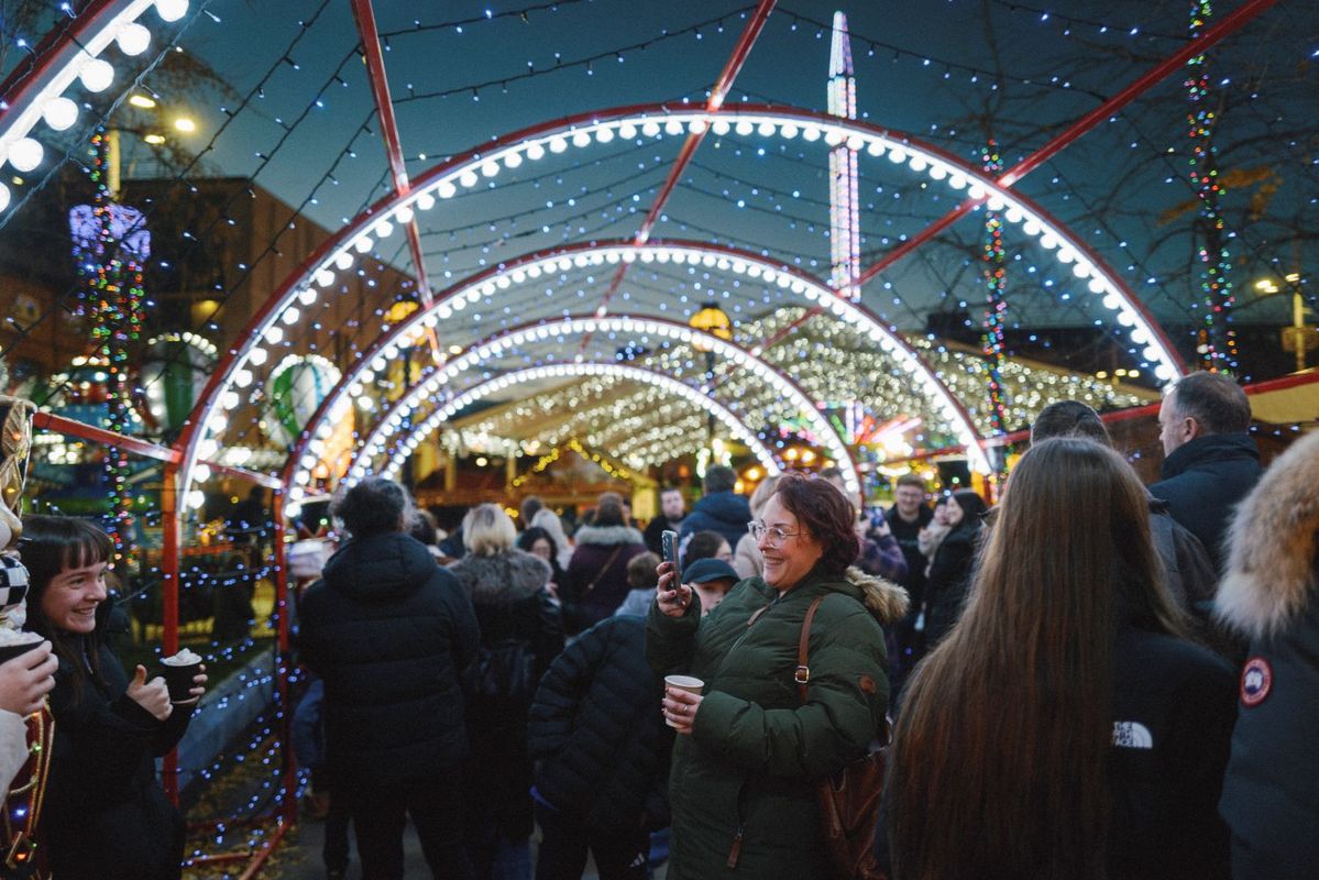Crowds enjoying festive lights and attractions