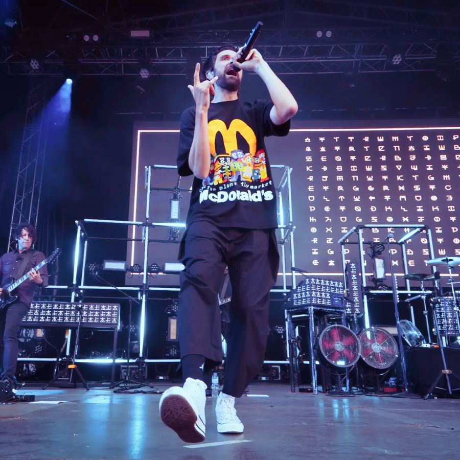 Kasabian singing on stage at Millennium Square