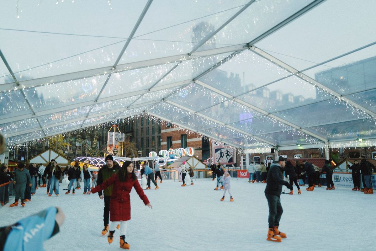 Visitors ice skating on the covered outdoor rink