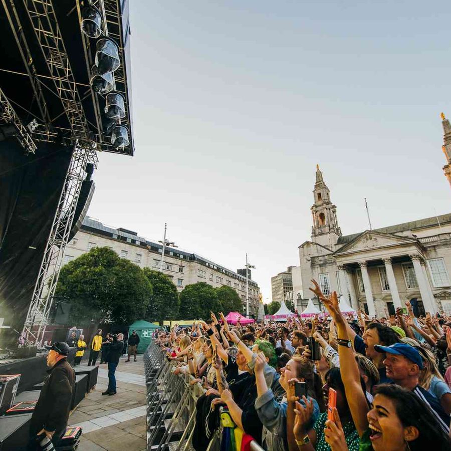 HAIM performing in front of the crowd on Millennium Square