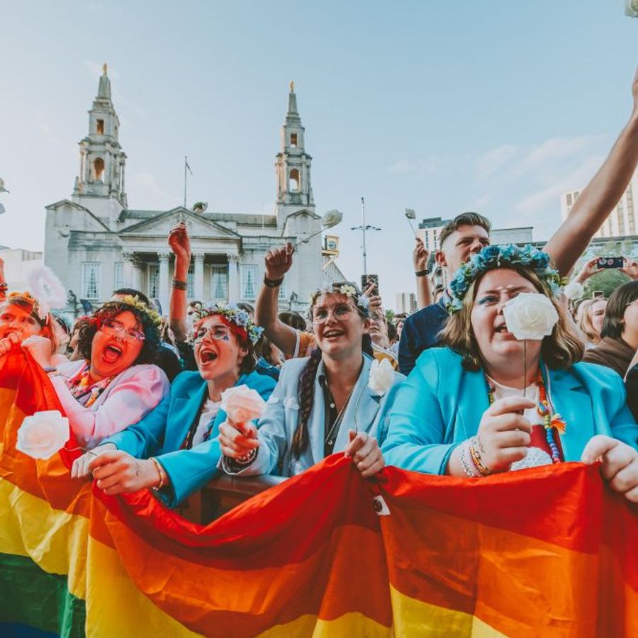Crowd at the front barrier holding a rainbow flag at Millennium Square Leeds during Mika’s 2025 Summer Series concert