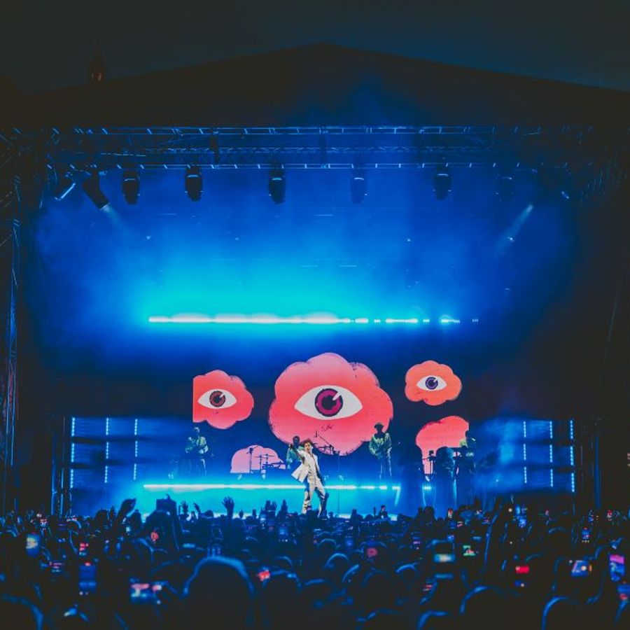 Wide view of Mika performing to a large crowd at Millennium Square Leeds at night during the 2025 Summer Series