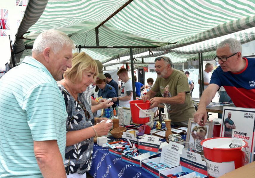Two people browsing a stall at the Armed Forces Day event