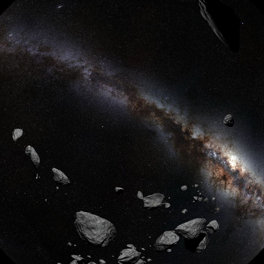 Asteroids floating against a backdrop of the Milky Way galaxy and a dense field of stars.