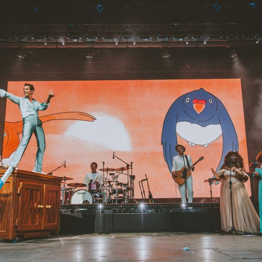 Mika performing on stage with band and large screen visuals at Millennium Square Leeds during the 2025 Summer Series