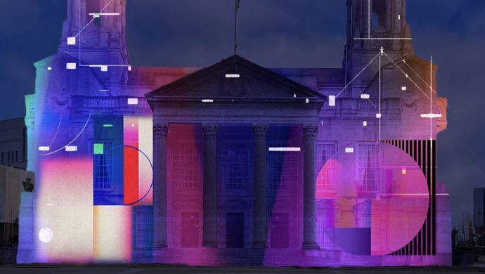 Colourful geometric light projection covering the façade of Leeds Civic Hall