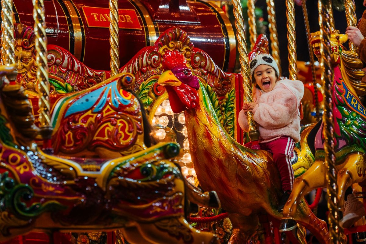A close-up of a young child on the carousel